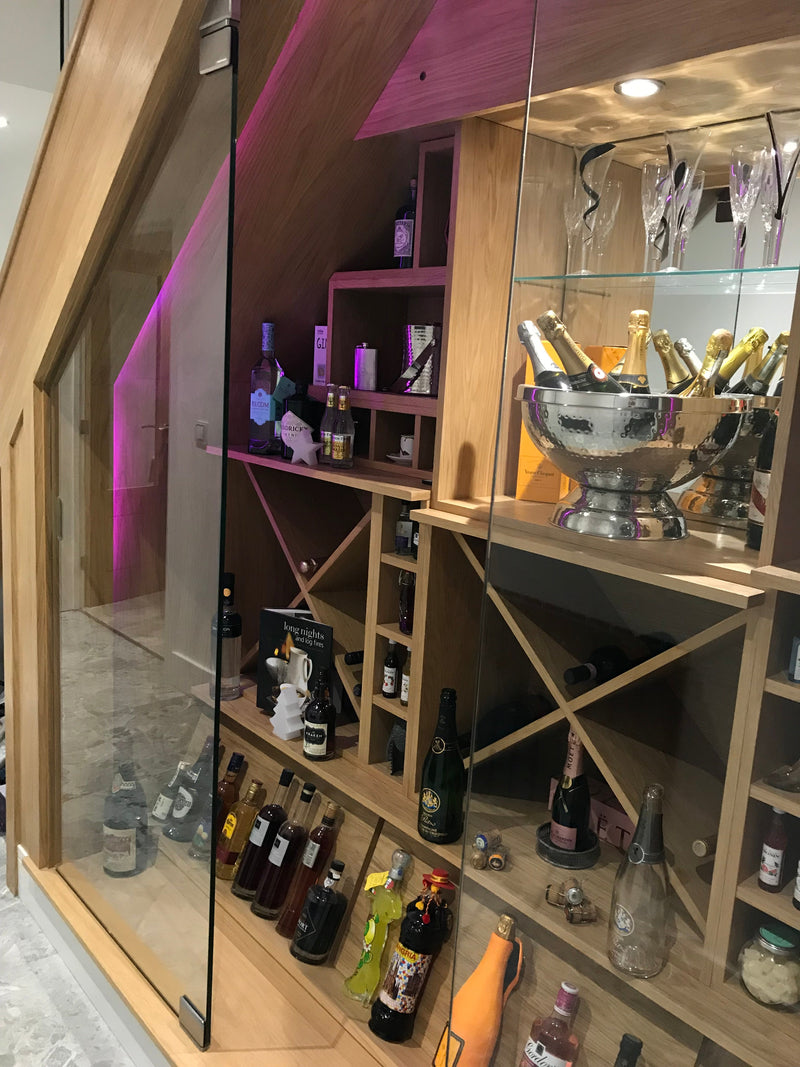 Glass doors to an under stairs wine store