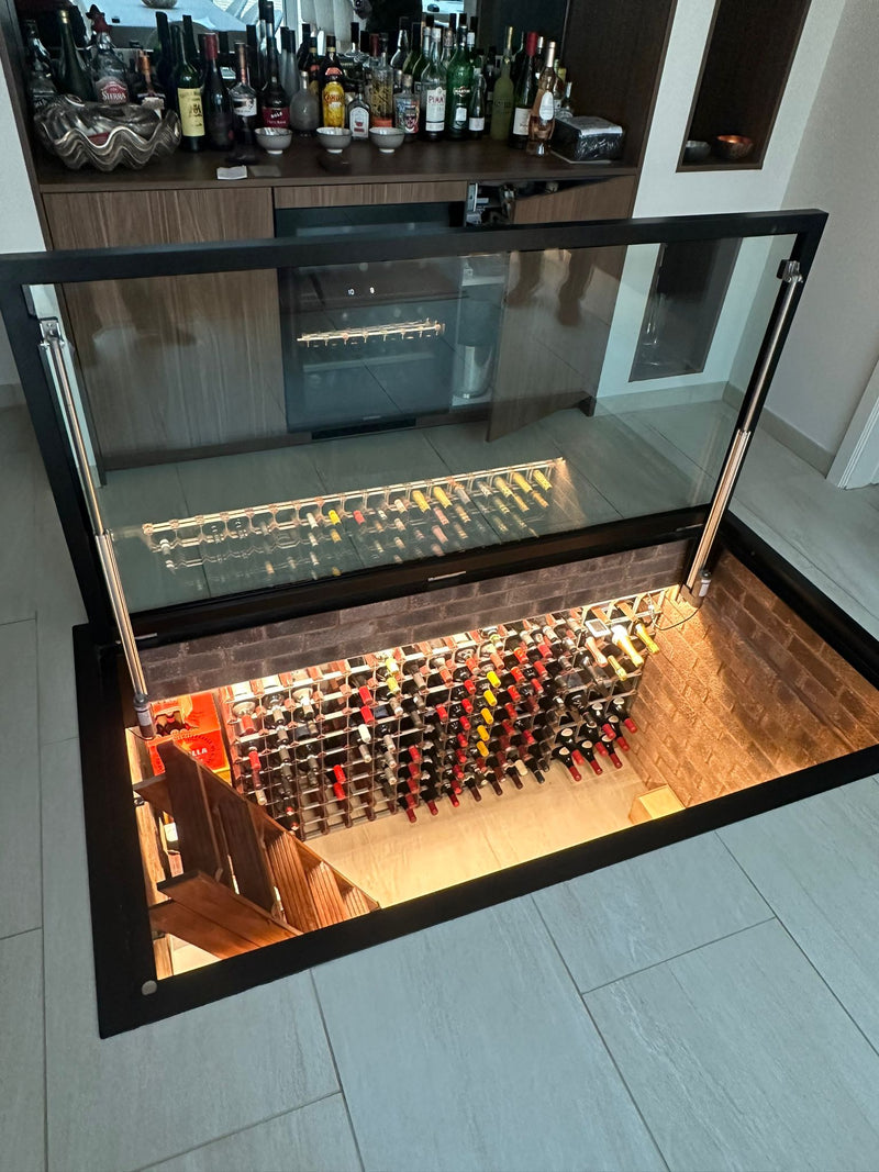 Custom electric glazed floor door over a wine cellar, motorised and opening flush with the floor