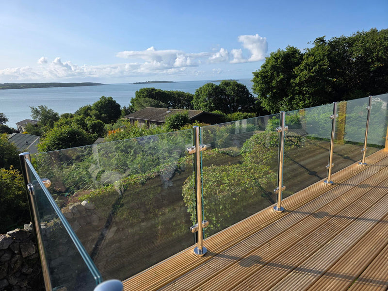 Laminated glass balustrade panels along a decked terrace