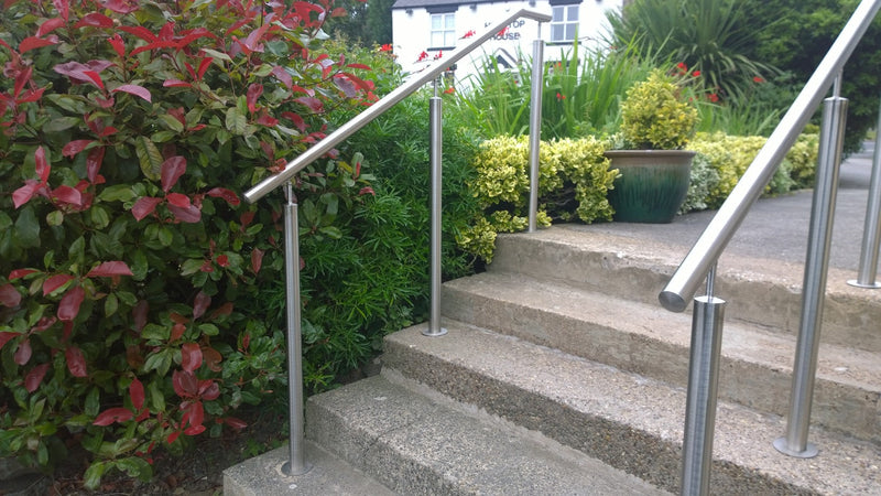 Stainless steel handrail on posts alongside external steps