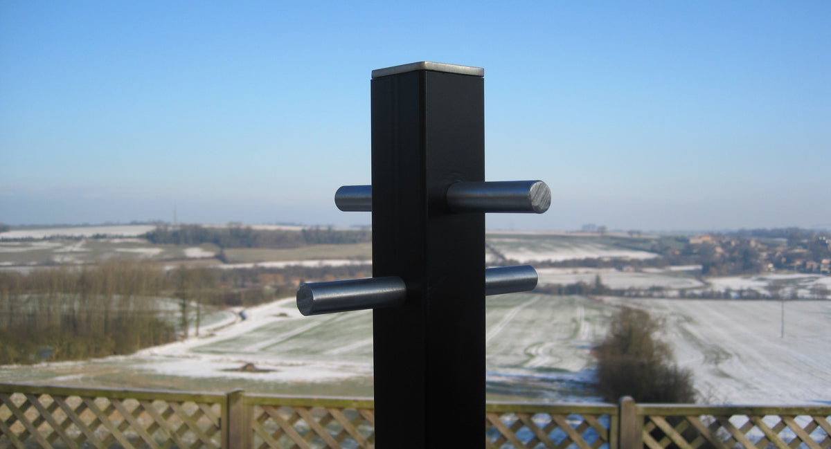 Modern style washing line pole in a garden overlooking open fields