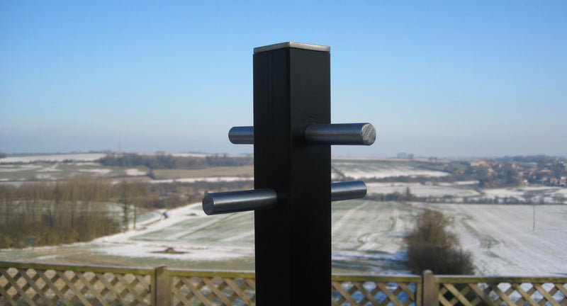 Modern style washing line pole in a garden overlooking open fields