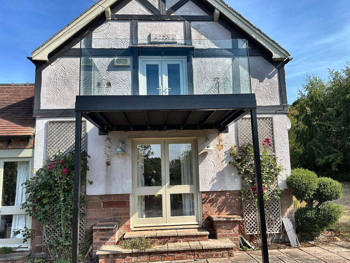 Frameless glass walk-out balcony with composite decking, Malpas, Cheshire