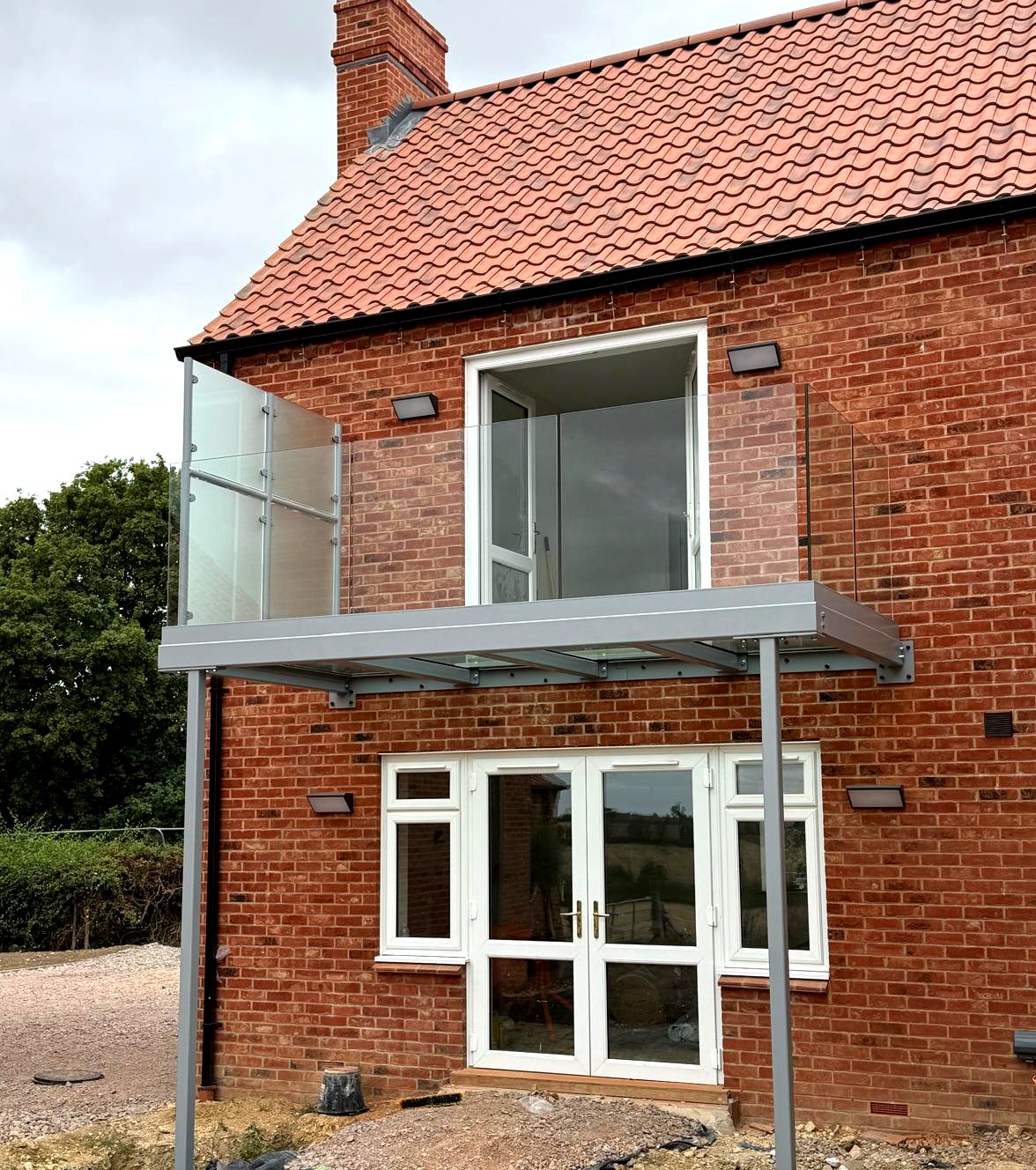 Walk-out balcony with a walk-on glass floor over patio doors, frameless glass balustrade, Whissendine