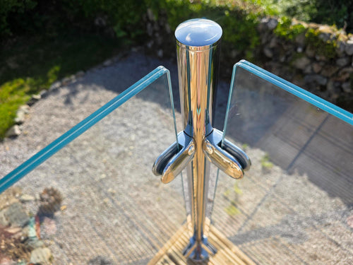 Stainless steel corner post holding a 10.8mm toughened laminated glass panel with the interlayer visible in the polished edge
