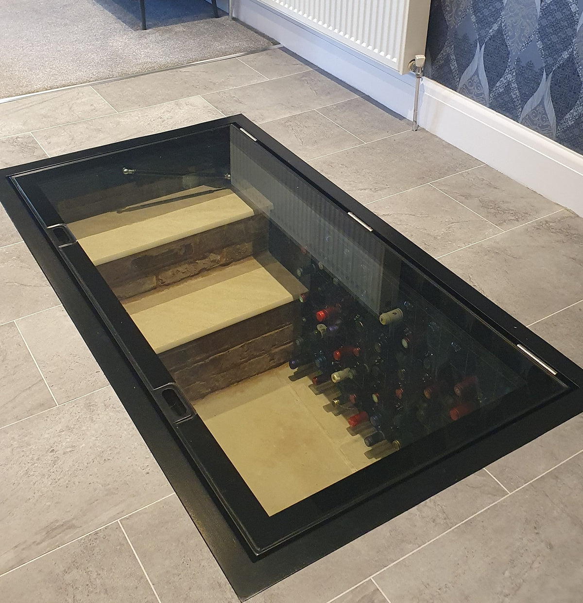 Ready made glass cellar door set into a modern kitchen floor
