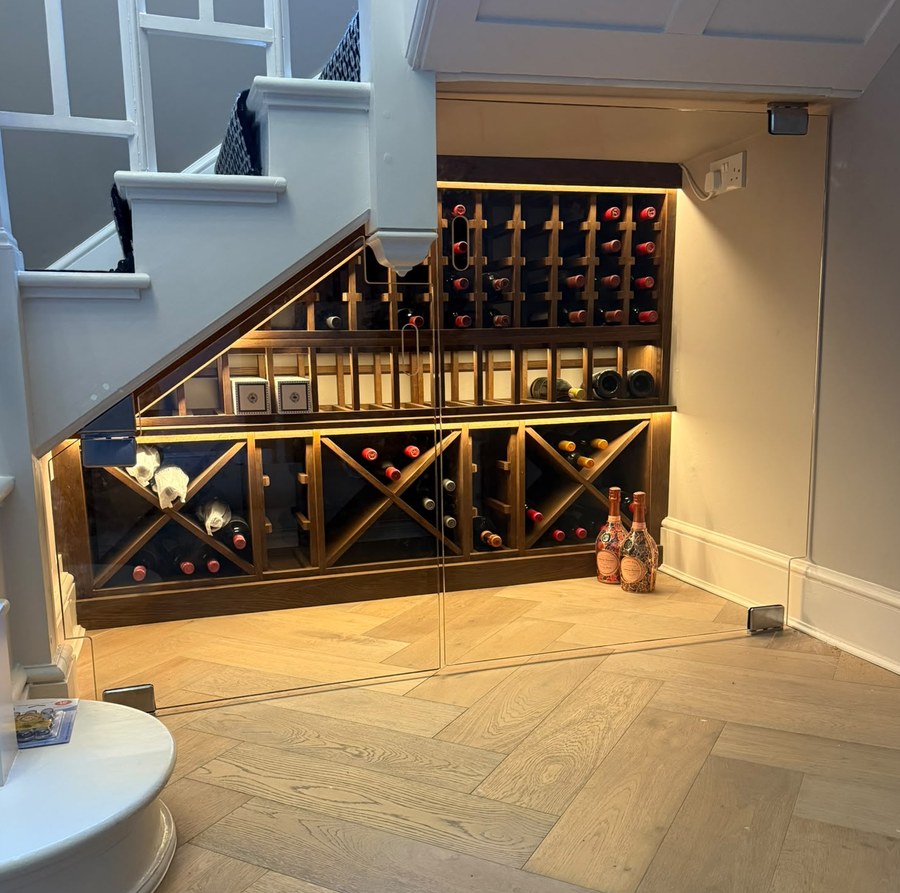 Frameless glass doors raked to follow the stair soffit, Cheshire