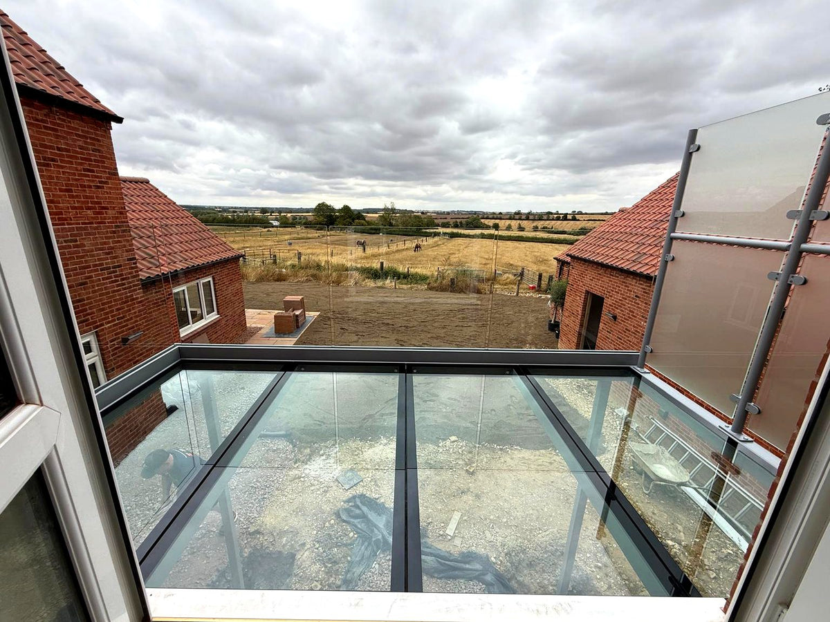 Looking across a walk-on glass floor balcony to open countryside, Rutland