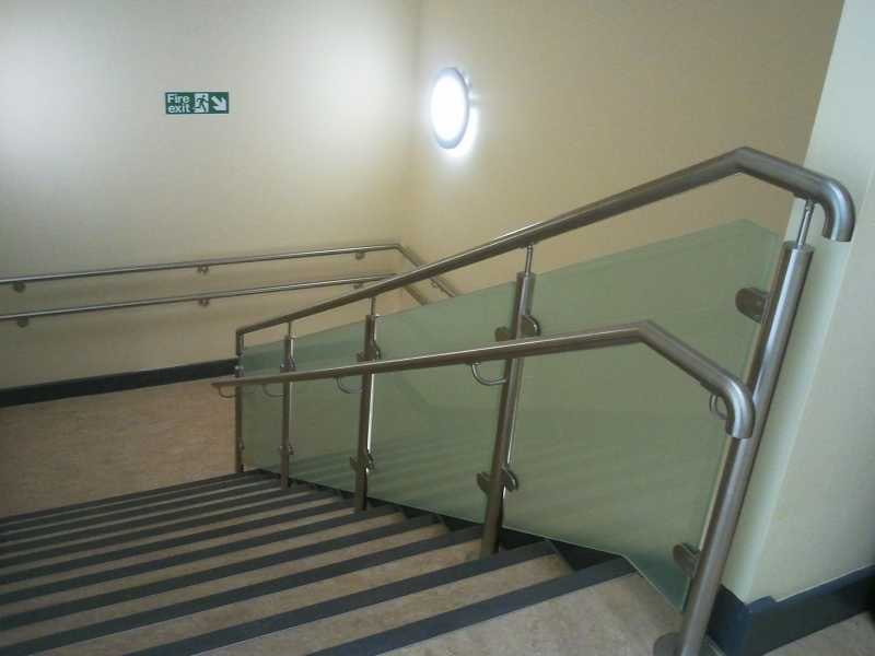 Wall fixed stainless steel handrail with a sweeping return end