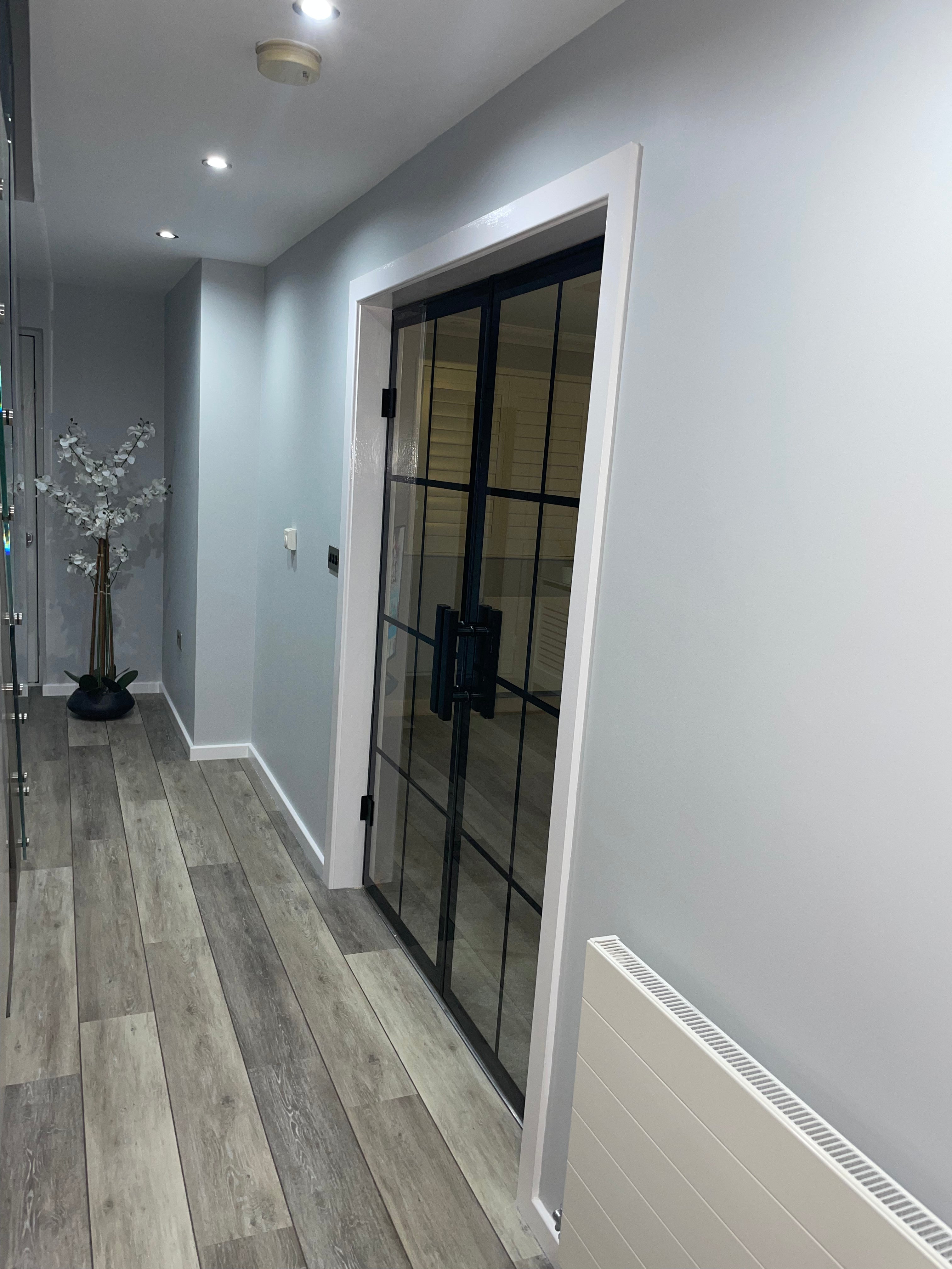 Glass partition doors hung on stainless steel glass brackets