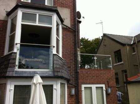 Stainless steel handrail run ending in wall rose flanges at both ends