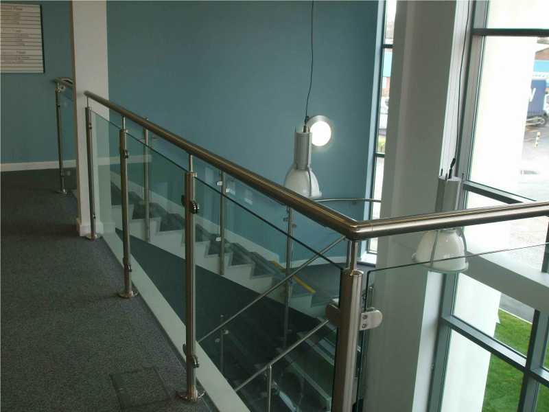 Brushed stainless steel balustrade posts with glass infill panels