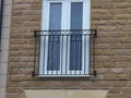 Galvanised steel Juliet balcony with a criss cross feature and square infill bars