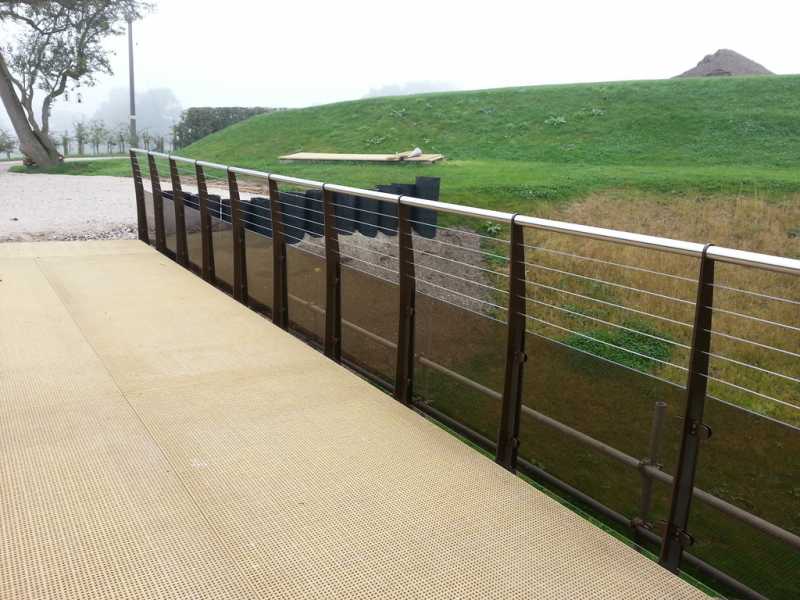 Bronze tinted glass balustrade against timber decking