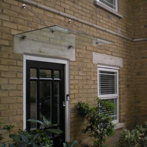 Suspended glass door canopy on stainless steel tie-rods