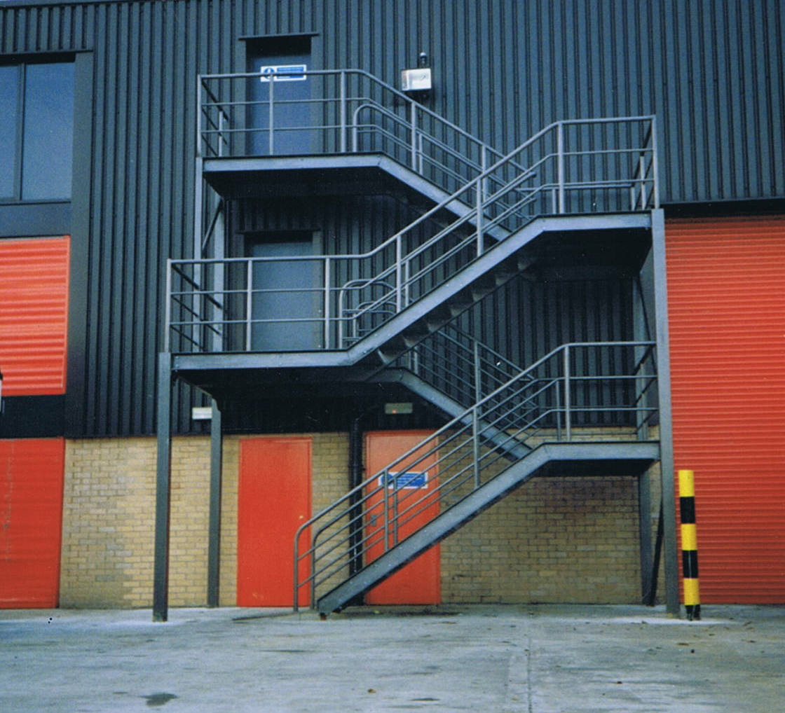 Commercial fire escape staircase with intermediate landing on an industrial unit