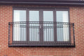 Curved ornate steel Juliet balcony with scroll patterns and a steel mesh floor