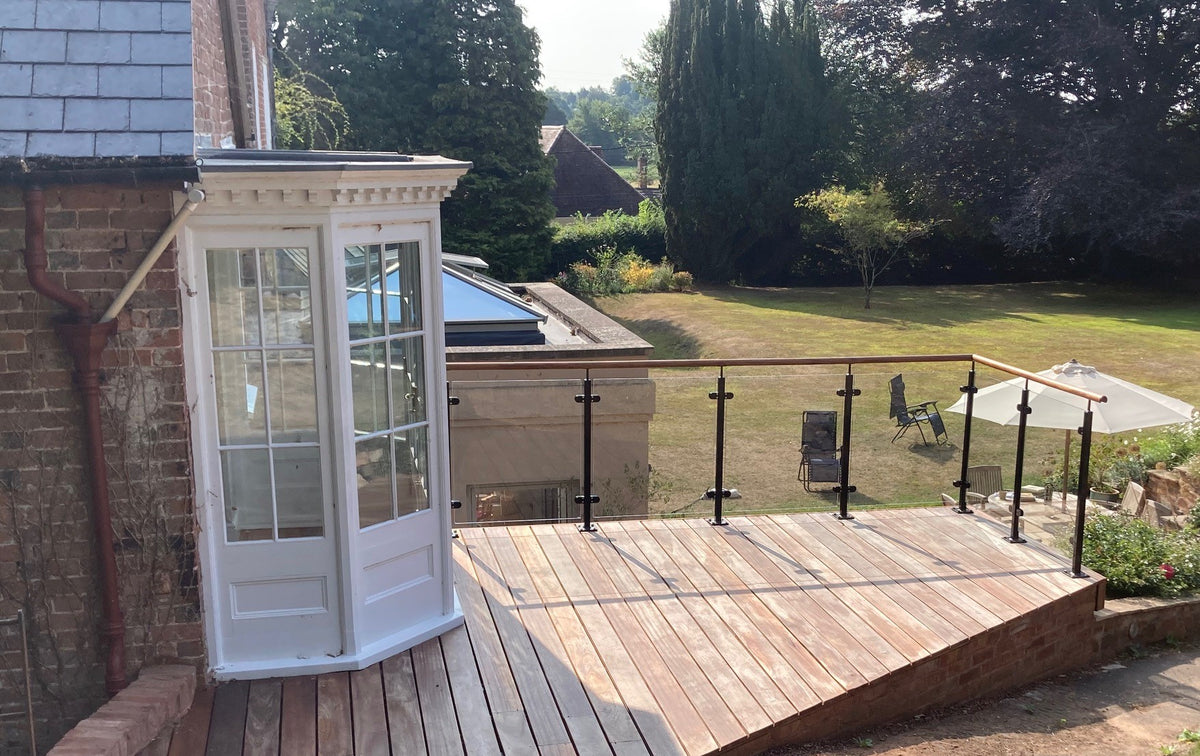 Custom powder coated glass balustrade with an oak handrail