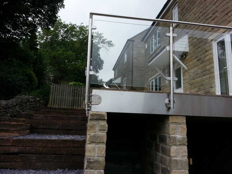 Face fixed stainless steel baluster posts with glass infill panels