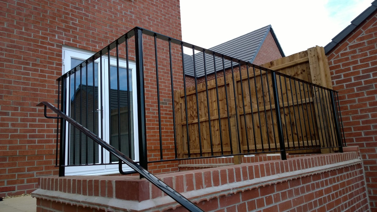 Metal wall top railing panels to a garden boundary