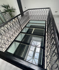 39mm walk-on laminated floor glass panels in a stairwell with a decorative metal balustrade