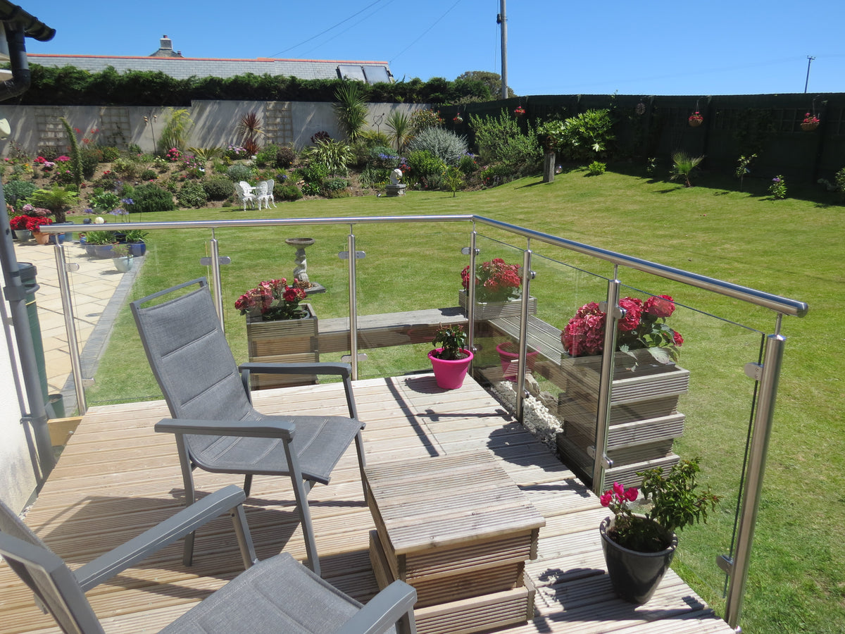 Brushed satin stainless steel balustrade posts holding toughened glass panels