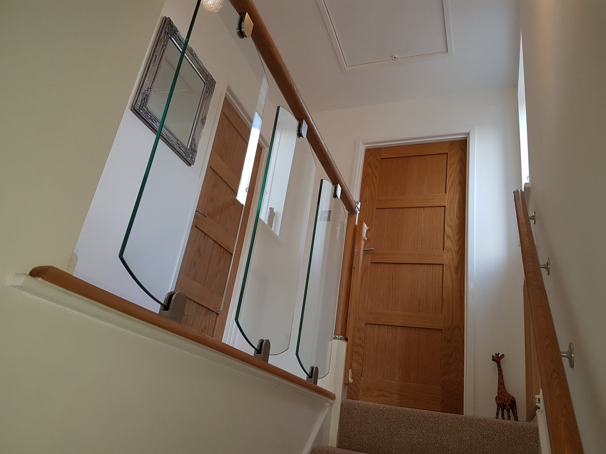 Shaped glass panels in place of stair balustrade spindles
