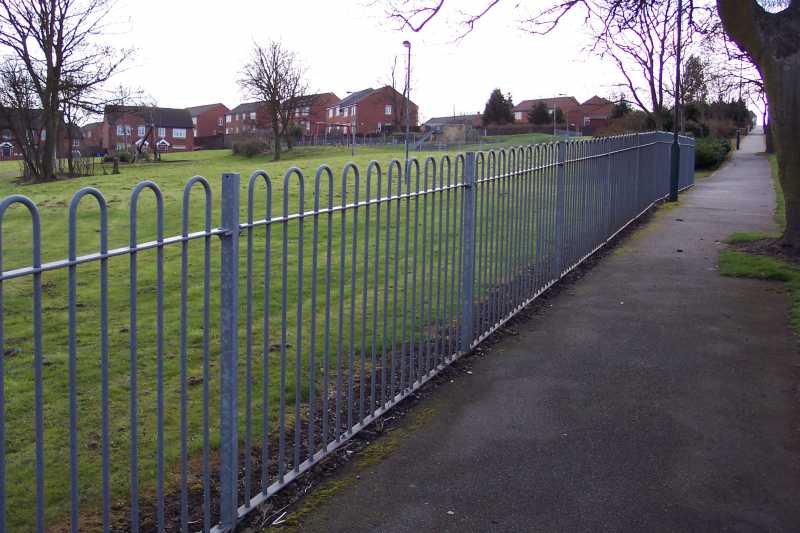 Solid bars formed into hoops along the top rail