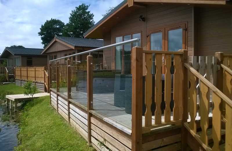 Decking railing on a caravan park with rails carried on upstand brackets