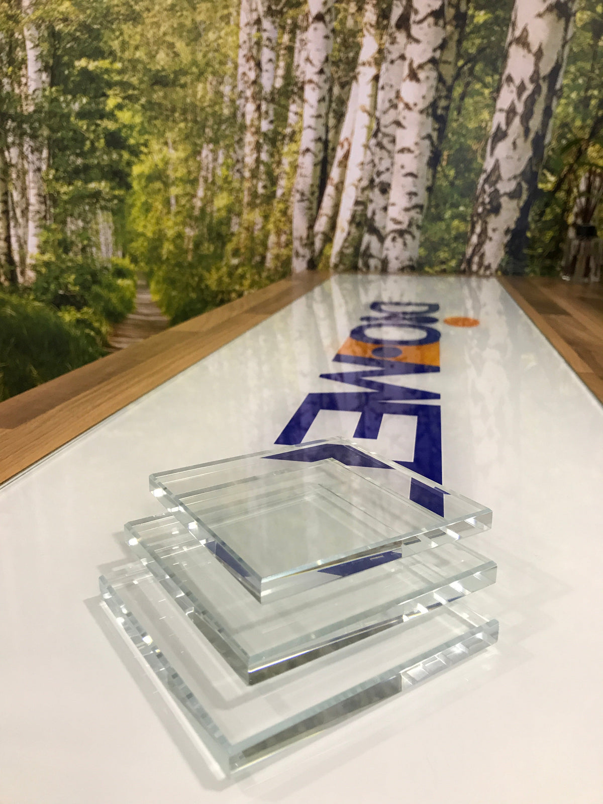 Stacked glass samples seen edge on, showing how much clearer low iron glass is than standard glass