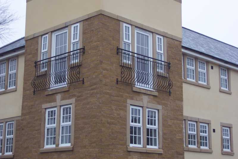 Galvanised steel Juliet balcony with Spanish bow infill bars and a tubular handrail