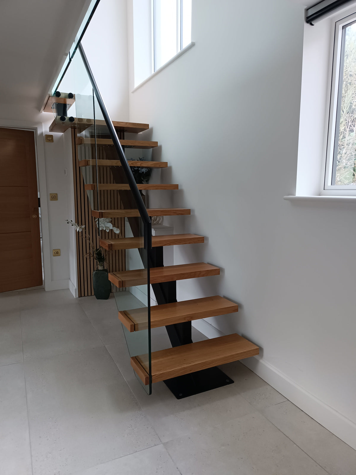 Floating oak tread staircase with frameless glass balustrade