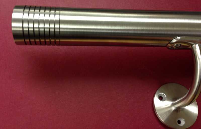 Stainless steel handrail with a multi grooved end cap
