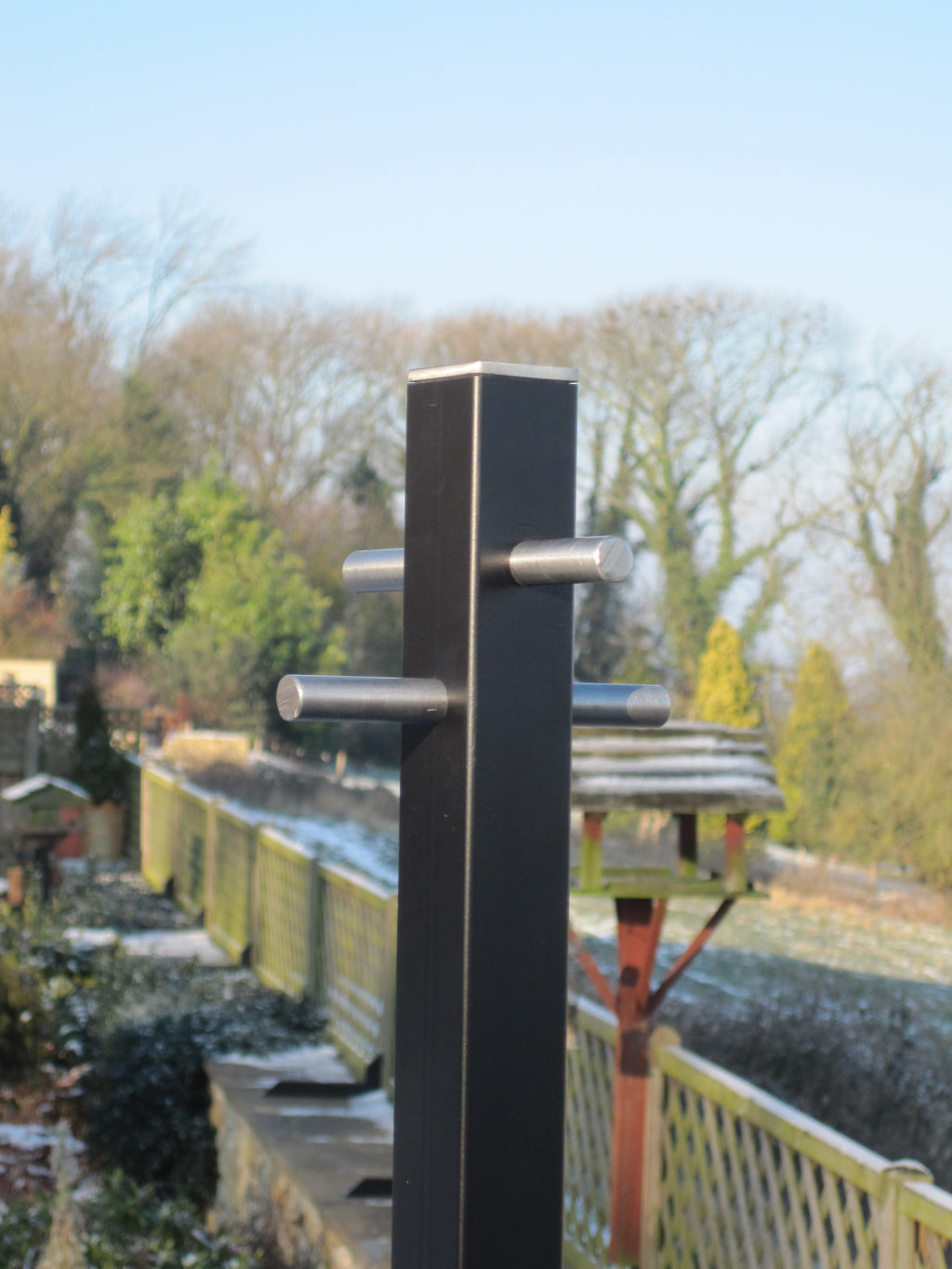 Anthracite modern washing line pole head against a garden and open countryside