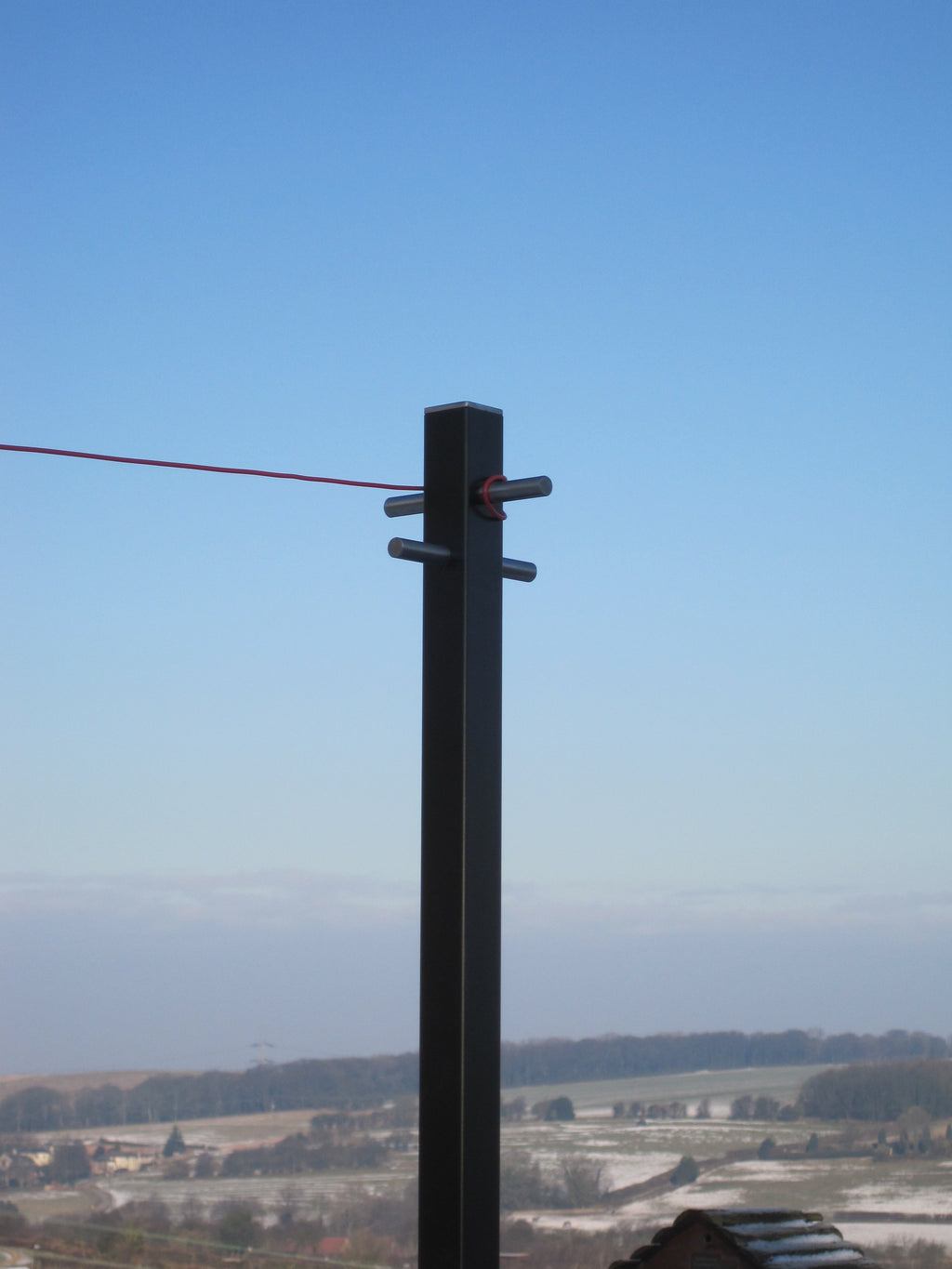 Modern washing line pole in use with a line running from the cross arm