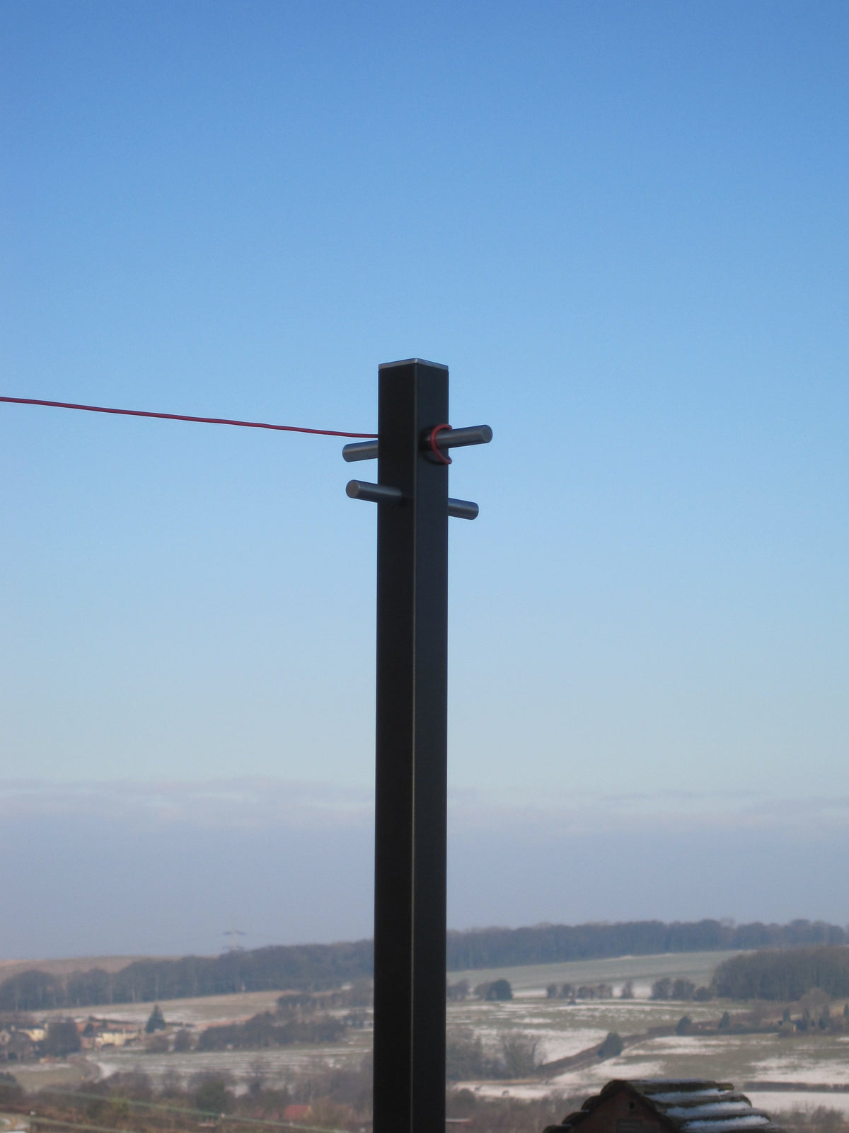 Modern washing line pole in use with a line running from the cross arm