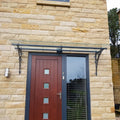 Powder coated ornate glass porch canopy over a front door