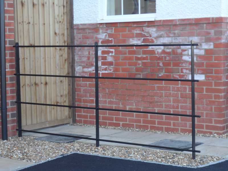 Estate rail fencing to a driveway boundary