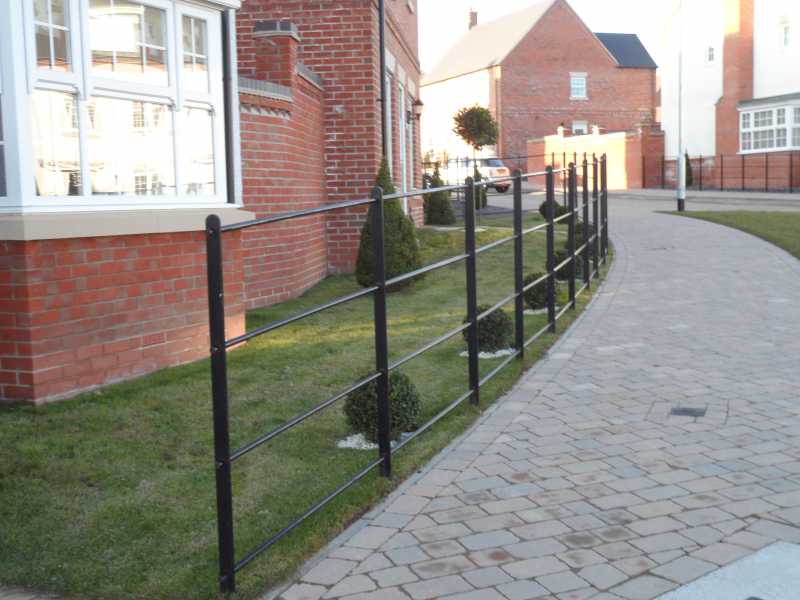 Horizontal estate rails passed through a drilled steel post