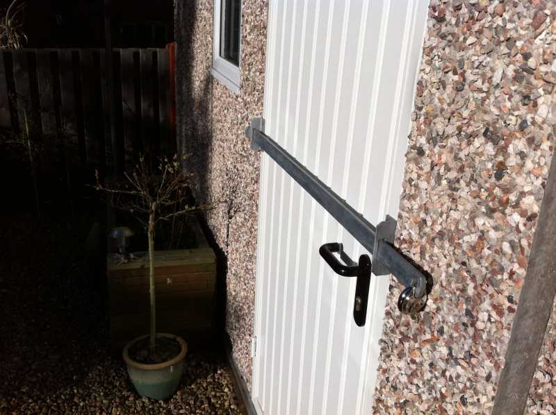 Shed security bar fitted across a shed door