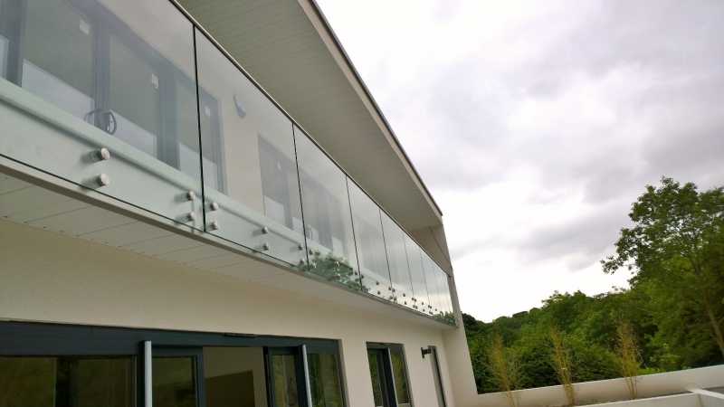 Side fixed frameless structural glass balustrade with slotted handrail