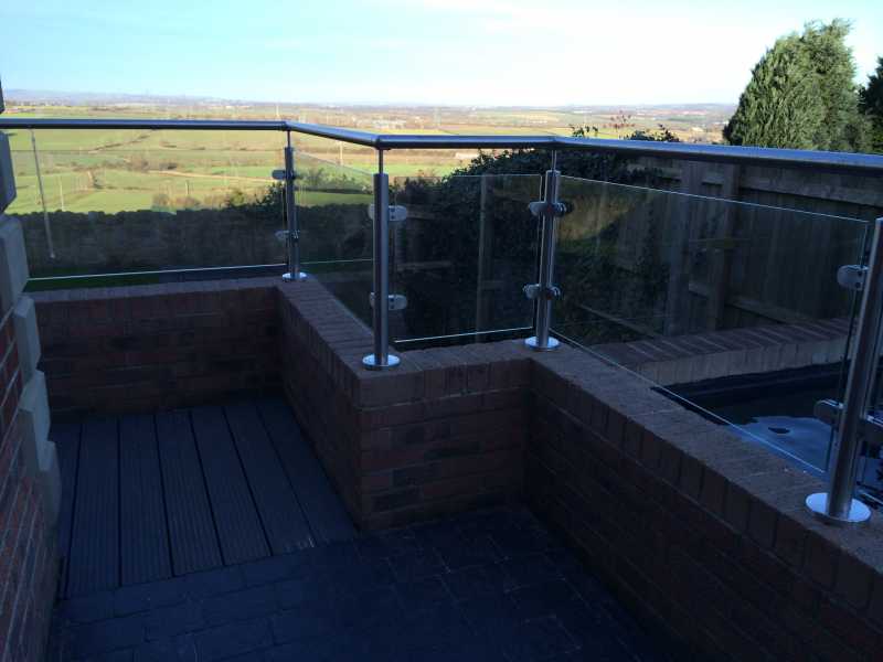 Stainless steel and glass balcony balustrade with concealed base plate fixings