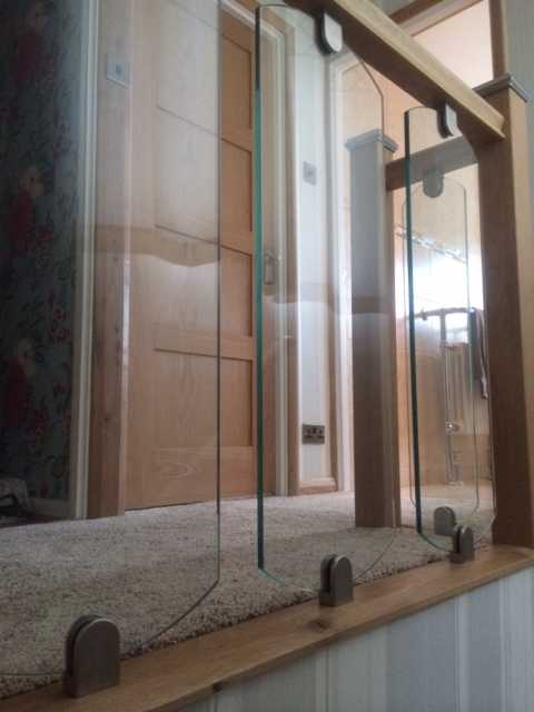 Shaped glass panel replacing timber spindles on a staircase