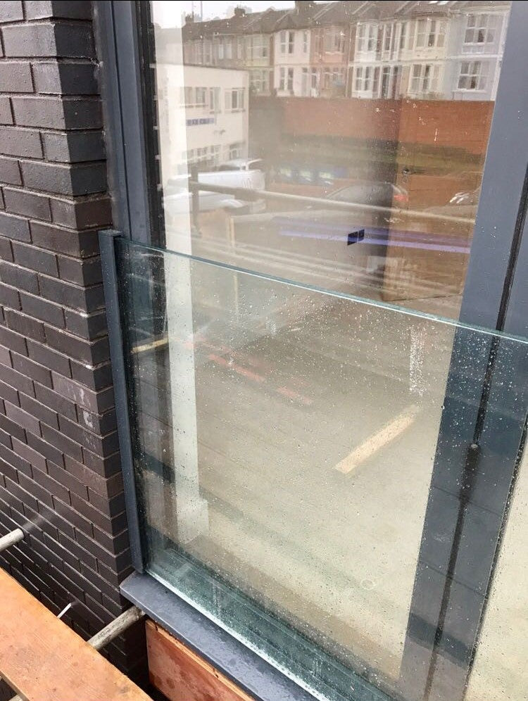 Frameless glass Juliet balcony across French doors