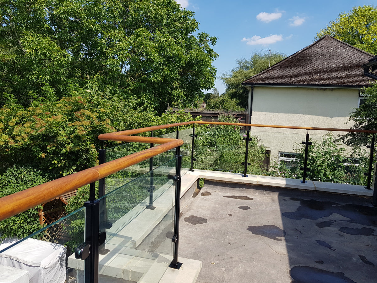 Powder coated steel glass balustrade with a solid timber handrail