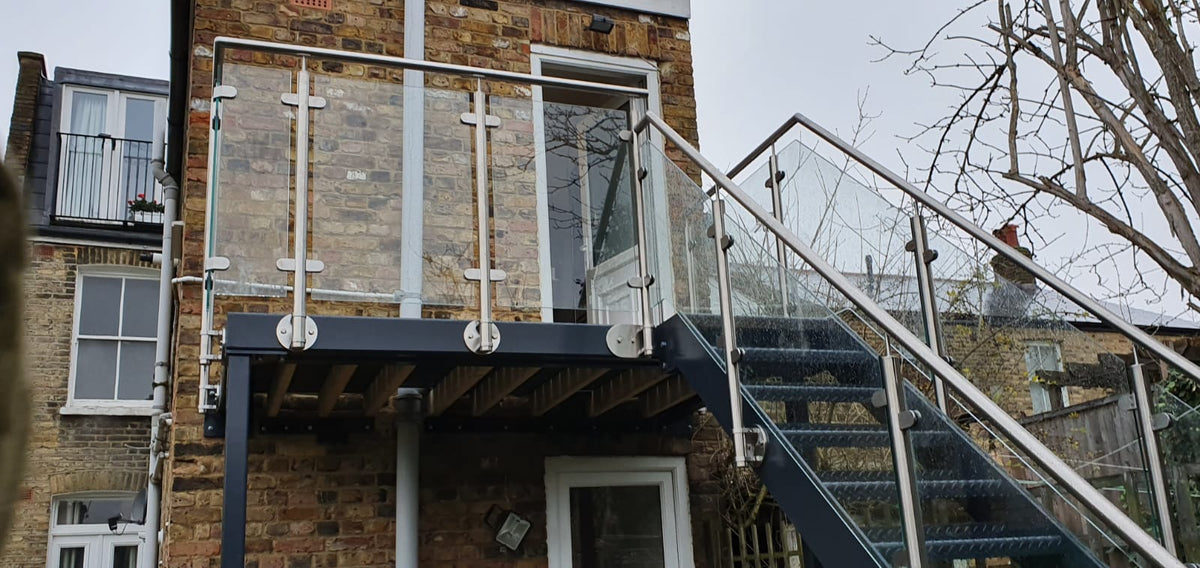 Powder coated steel walk out balcony and staircase with stainless glass balustrade