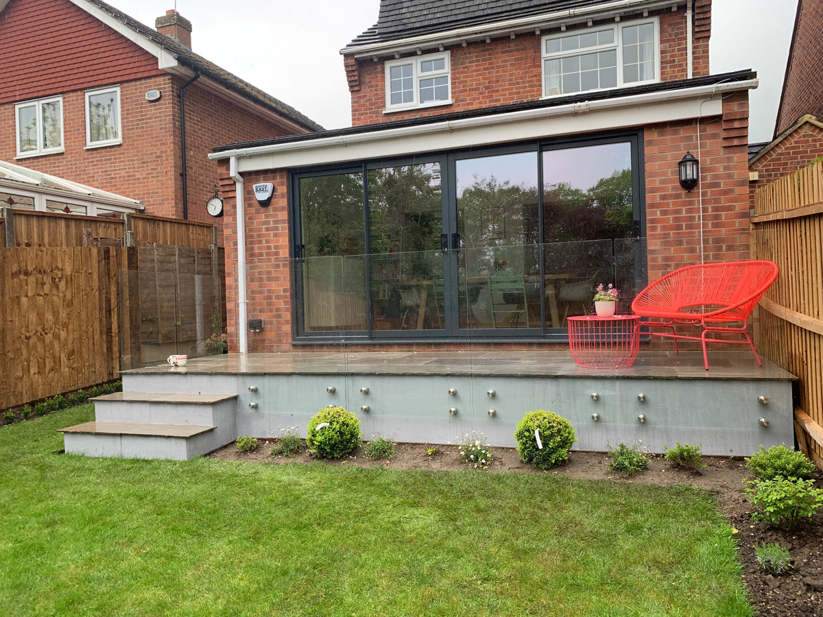 Low level frameless glass fencing to a patio edge