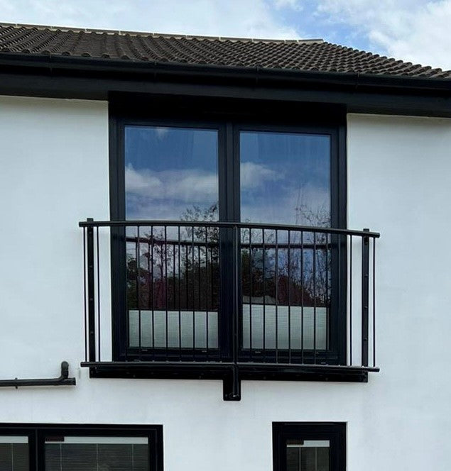 Curved metal Juliet balcony with 12mm solid infill bars