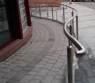 Curved stainless steel handrail with a returned end termination