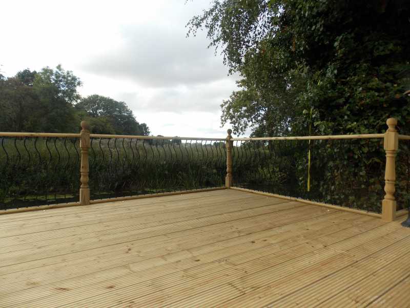 Decorative metal deck panel fitted to a timber deck